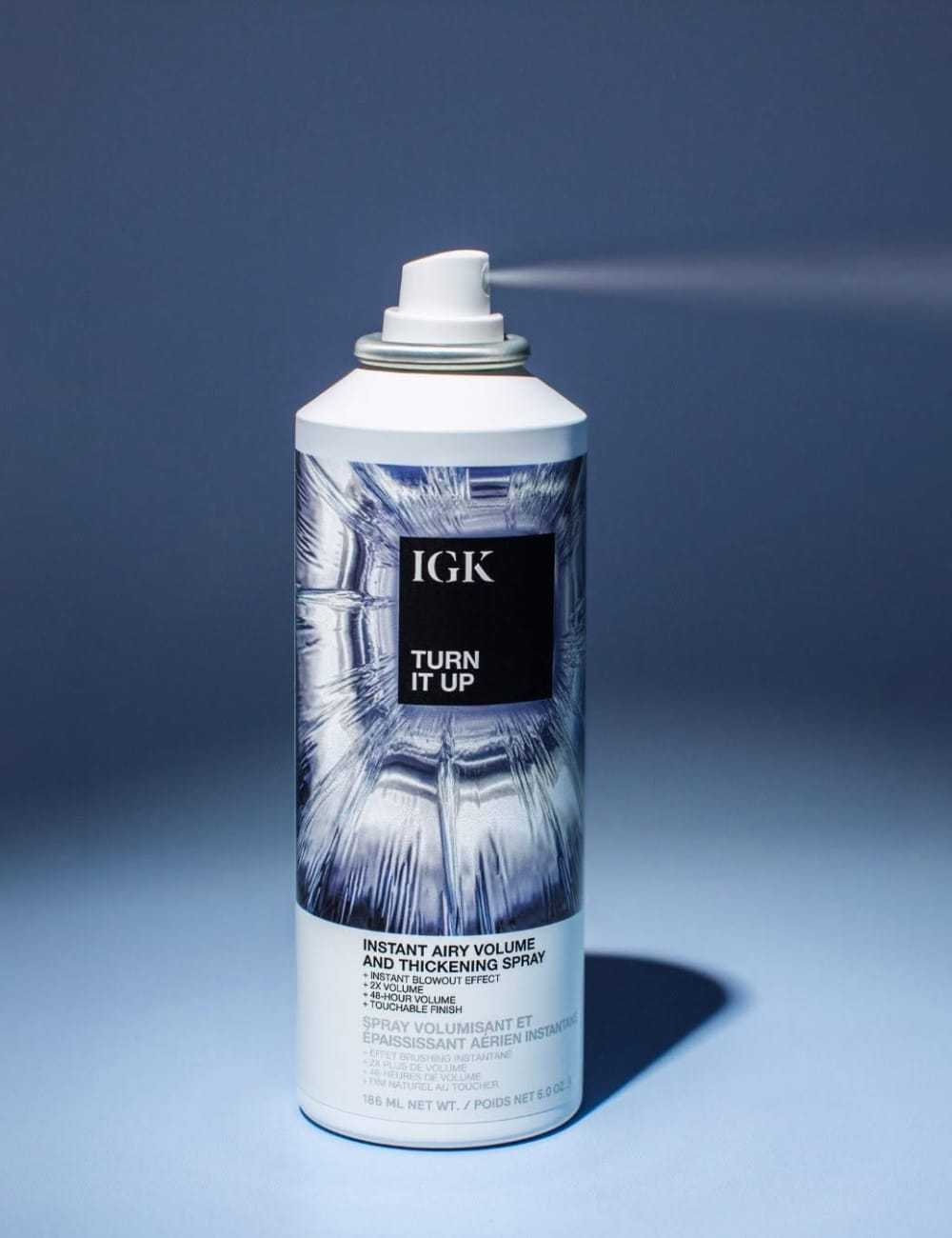 IGK Turn It Up Volumizing Spray can with a blue background.