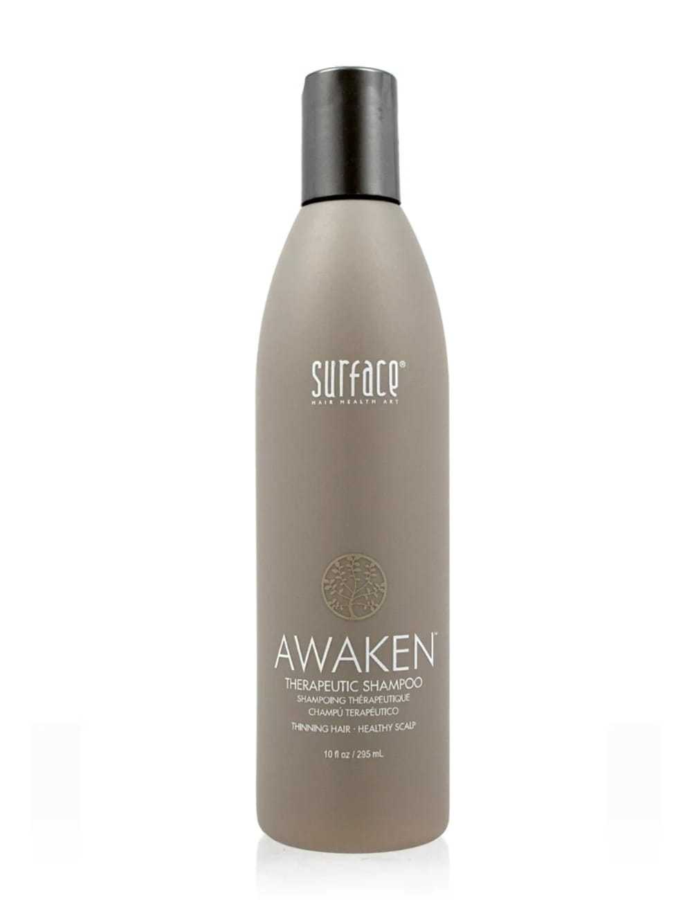 Surface Awaken Therapeutic Shampoo in a taupe bottle. Promotes healthy scalp and hair growth.
